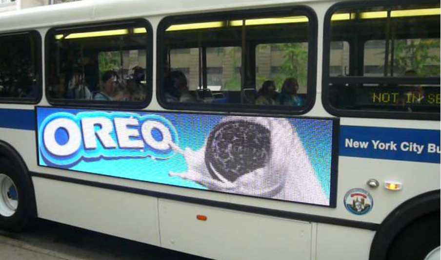 bus displaying digital transit ad from Oreo